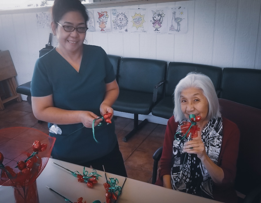 Staff and resident making holiday decorations