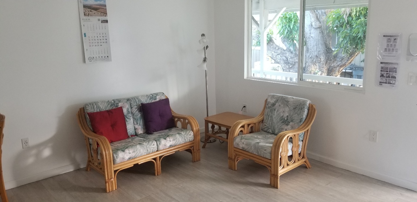 Sitting room with rattan furniture and Korean calendar